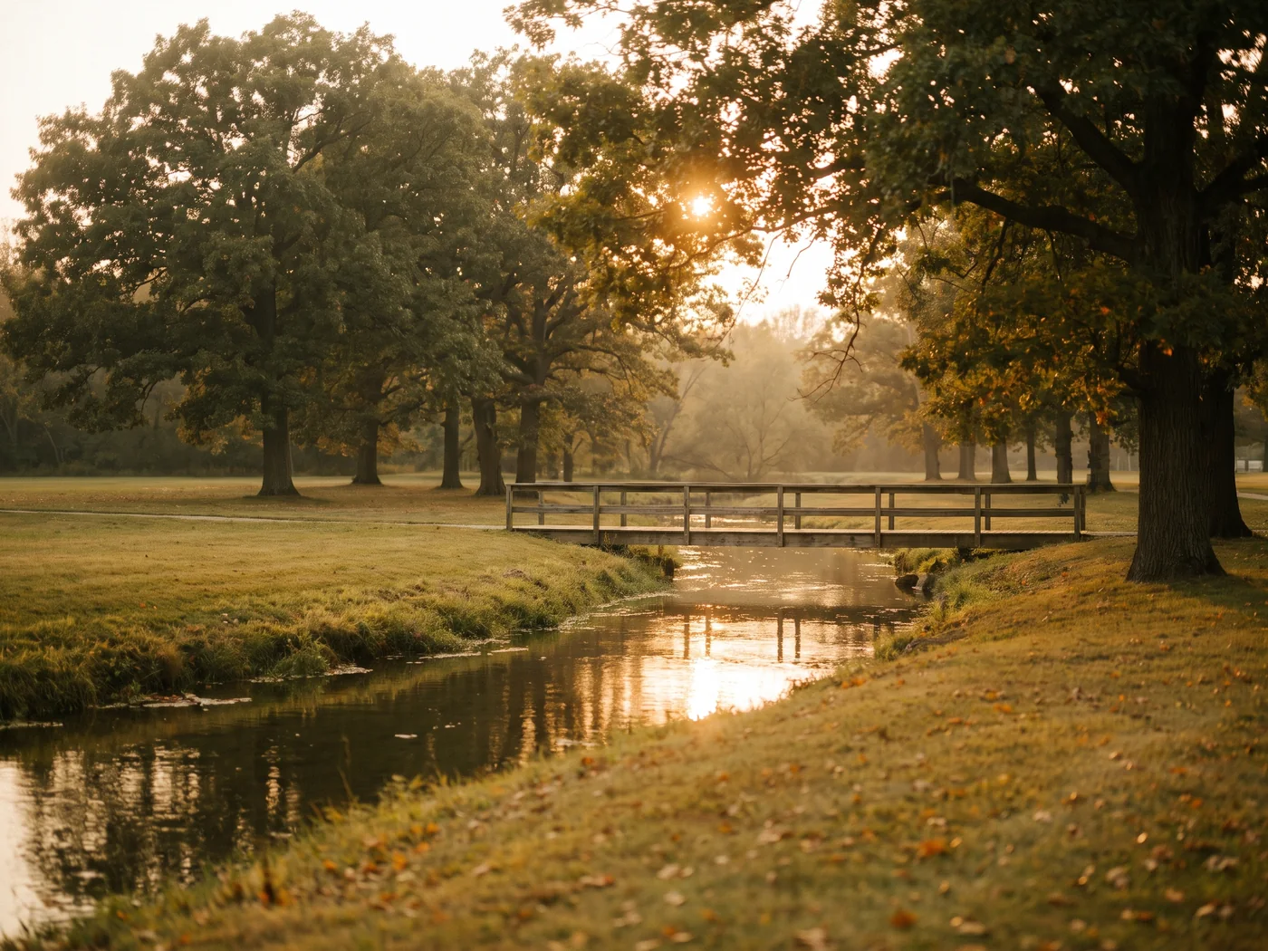 A tree lined river and footbridge in late afternoon light. Inspired Law Group serves Plainfield and the surrounding Will County communities.
